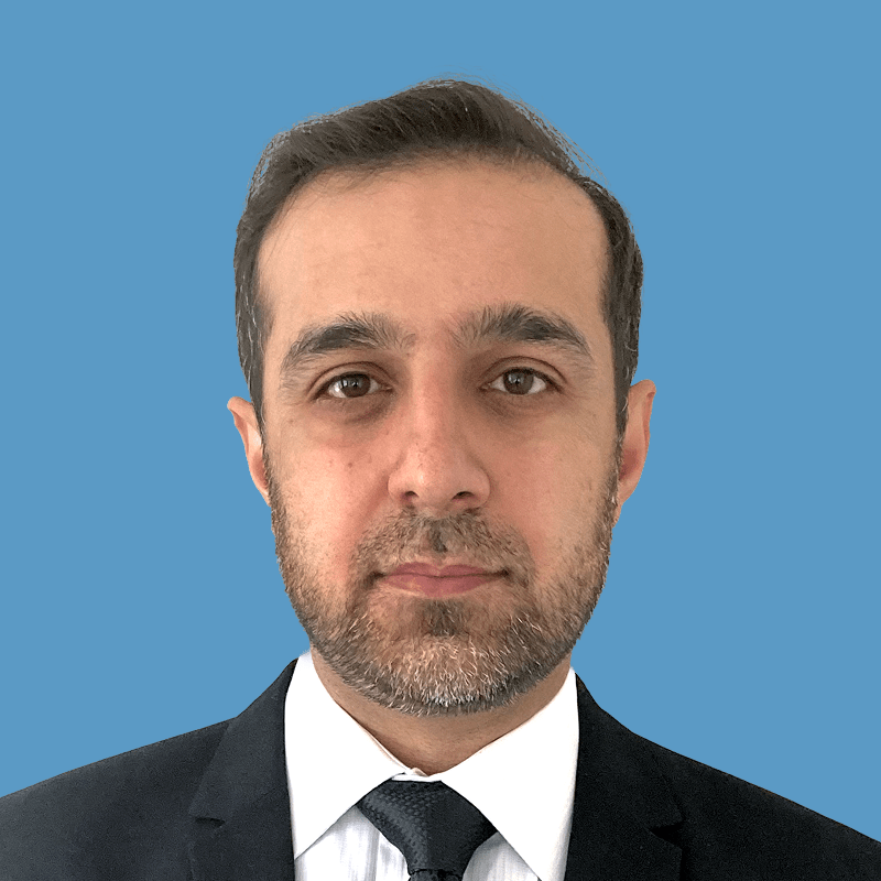 Headshot of Atif Rizvi, a middle-aged man with dark hair, beard, and wearing a suit and tie.